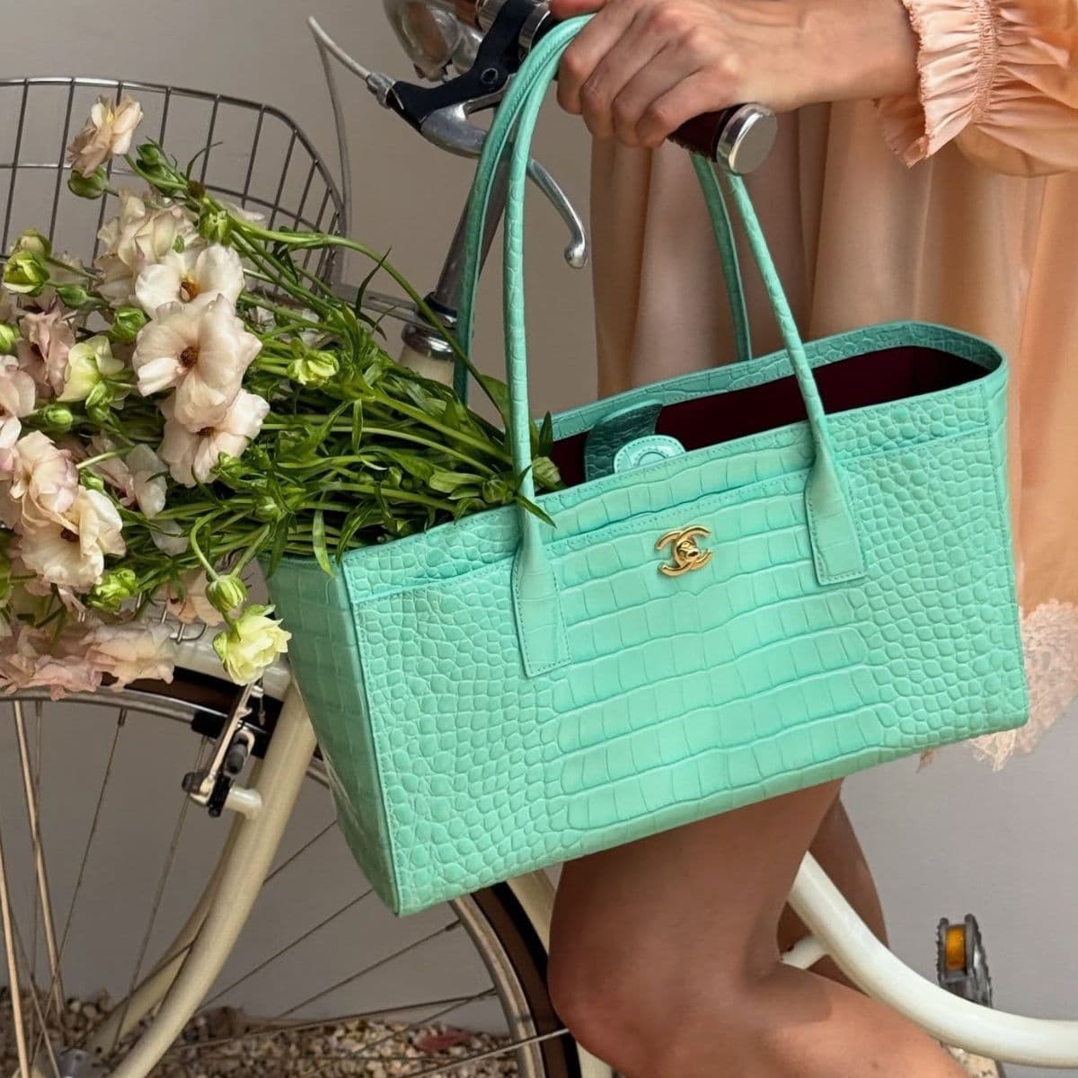The New Cool-Girl Status Symbol? Hanging One of These Beauty Products on Your Handbag